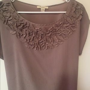 Size medium rose colored top with flower accents